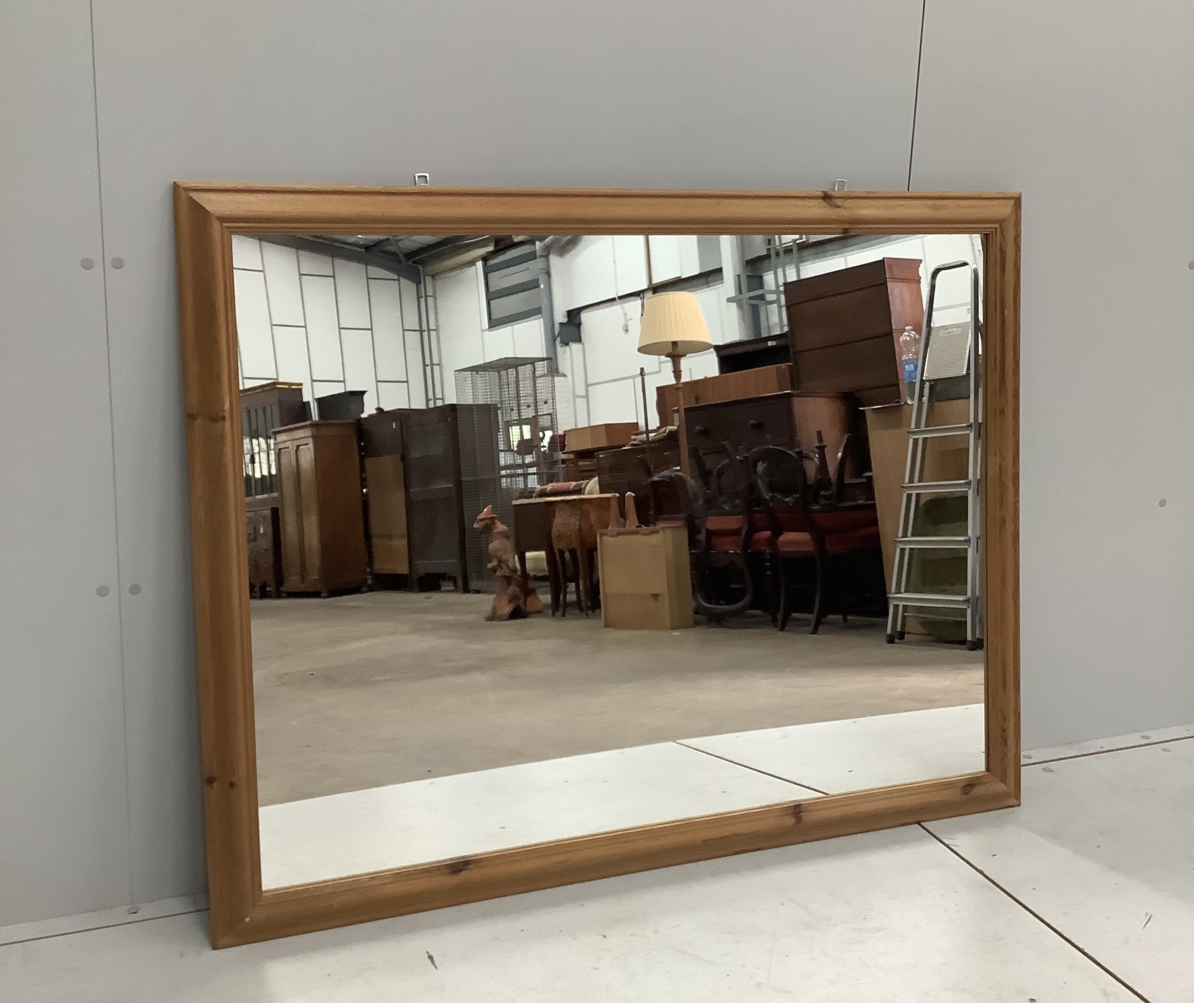 A rectangular pine framed wall mirror, width 132cm, height 102cm